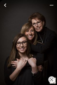 two women hugging and smiling for the camera with their arms around one woman's shoulders