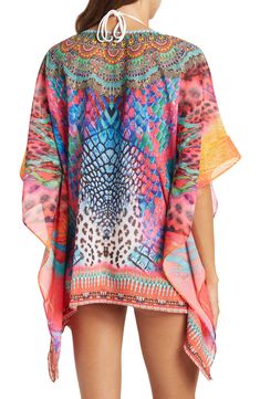 Unleash your free boho spirit in this poncho styled with vivid allover patterns and beaded embellishments. 28'' length (OS) V-neck Kimono sleeves All-over print Woven 100% polyester Dry clean Imported Model stats: 5'10", 32" bust, 25" waist, 36" hip. Model is wearing size OS. Bohemian Multicolor Printed Cover-up, Bohemian Multicolor Tunic Cover-up, Multicolor Poncho For Beach Cover-up In Summer, Multicolor Long Sleeve Poncho For Beach, Multicolor Long Sleeve Poncho For The Beach, Multicolor Poncho For Beach Cover-up, Multicolor Poncho For Summer Beach Cover-up, Multicolor Kimono Sleeves Cover-up For Festival, Multicolor Kimono-sleeved Cover-up For Festivals