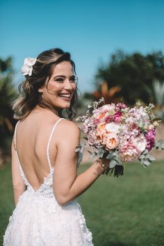 a woman in a wedding dress holding a bouquet