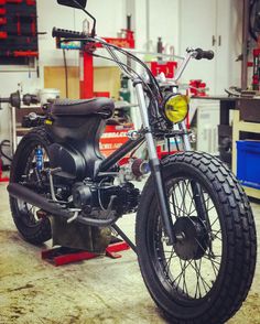 a motorcycle parked in a garage next to some tools