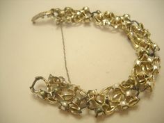 "Vintage Lisner 1950's 7\" gold tone metal, aurora borealis rhinestones bracelet. Six sections each consisting of six faceted aurora borealis rhinestones. All stones are faceted, present and intact. Standard flip over clasp signed \"Lisner\" with a safety chain.. Excellent condition--not mint. Very sparkly! Pretty!" Vintage Gold Bracelets With Sparkling Details, Vintage Gold Bracelets With Bling, Vintage Gold Bling Bracelets, Vintage Gold Crystal Bracelet With Rhinestones, Rhinestone Ring, Safety Chain, Pearl Pendant Necklace, Rhinestone Bracelet, Gorgeous Bracelet