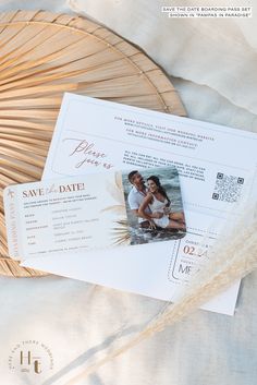 two save the dates cards sitting on top of each other next to a wicker basket