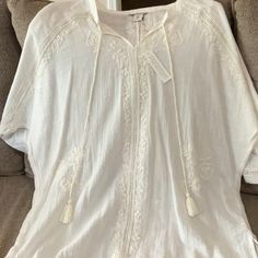 Rachel Zoe Size Medium Boho Embroidered Ivory Cream Tassel Tie Blouse. 99% Cotton Nwt White Cotton Top With Back Tassel Tie-up, White Beach Top With Back Tassel Tie-up, White Cotton Top With Tassels, Spring Blouse With Tassel Ties And Short Sleeves, White Tops With Tassel Ties For Vacation, Spring Blouse With Short Sleeves And Tassel Ties, White Tassel Tie Top For Vacation, White Bohemian Blouse With Back Tassel Tie-up, White Cotton Tops With Back Tassel Tie-up