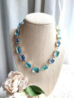 "Mixed shape collet necklace created with vintage swarovski crystals in aquamarine and pale sapphire blue. I wonderful mix of pear and octagon shapes and very soothing colors to wear to the office or an evening out...why not even with your favorite jean jacket? The settings are lacquered brass in gold, with custom artisan created findings. It's 16\" with a 2\" extender. This necklace is lovely for environmentally conscious women. All of the rhinestones are old stock swarovski and Czech glass, fr Light Blue Necklace, Peach Necklace, Clear Necklace, Green Statement Necklace, Peridot Color, Blue Statement Necklace, Edwardian Jewelry, Crystal Choker Necklace, Peridot Necklace