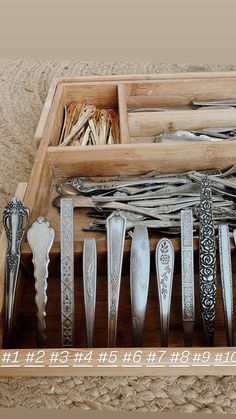 a wooden box filled with lots of different types of knives