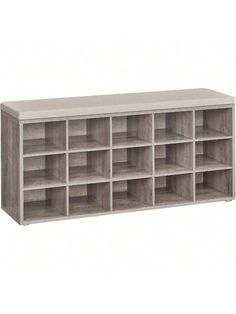 the shelf is made from wood and has many compartments