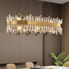 a modern chandelier hanging over a dining room table