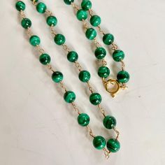 Stunning malachite beads necklace adorned with gold beads and finished off with a sparkly cz clasp can absolutely be used as a charm holder. Length 16" Wire wrapped malachite necklace rosary style. Length 18" Malachite, with its pure green ray is a "growth crystal" a powerful conduit of the earth’s life force of birth, development, and creation, and of the power of nature’s constant renewal. It is a potent aid in nurturing, whether of fledgling family relationships or a new business venture. -Th Malachite Necklace, Charm Holder, Life Force, Business Venture, Family Relationships, Of The Earth, Beads Necklace, Gold Beads, Rosary