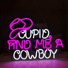 a neon sign that says cupid find me a cowboy