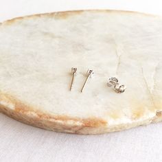 This pair of tiny sapphire stud earrings are made of white or yellow gold vermeil over sterling silver. They are super tiny. Only 2mm. Measurements: Width - 2mm S for Sparkle on Etsy https://www.etsy.com/shop/sforsparkleshop -------------------------------------------------------------------- S for Sparkle Mission We believe that everyone should have the power and access to practice self-validation. We strive to empower people with reminders of their inner values and worthiness through thoughtfu Classic Hypoallergenic Nose Studs Gift, Classic Tiny Earrings For Anniversary, Dainty Prong Setting Nose Studs As Gifts, Classic Round Nose Studs For Gifts, Tiny Silver Classic Earrings, Silver Minimalist Birthstone Earrings, Tiny Classic Silver Earrings, 14k Gold Nose Studs With Prong Setting Gift, 14k Gold Prong Setting Nose Studs For Gift