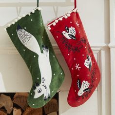 two christmas stockings hanging from a fireplace