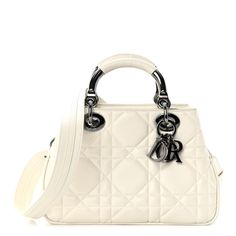 This is an authentic CHRISTIAN DIOR Calfskin Cannage Small The Lady 95.22 in Ivory.  Crafted by hand, this white calfskin leather bag is enhanced by iconic Dior 'Cannage' stitching. This handbag features leather top handles with classic Dior Logo charms, and an optional chain shoulder strap. The top opens to a matching suede interior with a pocket. Everyday Luxury Cream Leather Bags, Luxury Everyday Cream Bag, Luxury White Soft Leather Bag, White Leather Top Handle Shoulder Bag, Luxury Cream Shoulder Bag With Leather Lining, Designer White Shoulder Bag With Detachable Strap, Luxury White Bag With Palladium Hardware, Luxury Cream Shoulder Bag, High-end Cream Leather Bag