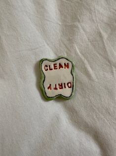 a close up of a cloth with a patch on it that says clean and dishwash