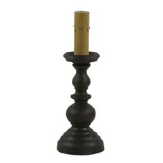 a black candle holder with a wooden stick sticking out of it