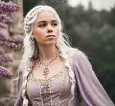 a woman with long white hair wearing a purple dress and gold jewelry standing in front of flowers