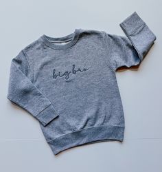 This sweet and simple embroidered big brother shirt is perfect for any little boy whether they are already a brother or about to become one.  This cozy sibling shirt features a black text on a grey t-shirt and is the perfect combination of comfort and cuteness! If you are interested in other colors, send me a message and we can find something that meets your needs!   Need a sweatshirt instead?  Check out this listing:  https://www.etsy.com/listing/1699144416/big-brother-sweatshirt-big-brother-shirt  Details: Thread is polyester Embroidery Wash and Care: -Always wash your garment before use -Wash inside out with mild detergent -Wash on cold, gentle cycle -Do not use chlorine bleach -Lay or hang to dry Items will ship USPS First Class.  Please contact us with any questions! Heather Grey Sweatshirt, Big Brother Shirt, Sibling Shirts, Brother Shirts, Gray Tshirt, Big Brother, Grey Sweatshirt, Embroidered Shirt, Kids Tops