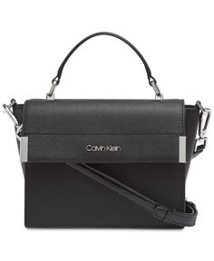 View More Calvin Klein Items   Calvin Klein Raelynn Saffiano Top Handle Flap Handbag Crossbody (Black/Silver) Poised, polished and ready to take on the day (or night), the Calvin Klein Raelynn Crossbody will remain a timeless classic for years to come. Mini sized bag; 6"W x 7"H x 3"D (width is measured across the bottom of handbag); 1 lbs. approx. weight Silhouette is based off 5'9" model 3-1/2"L handle; 23"L detachable strap Magnetic snap closure Silver-tone exterior hardware 1 interior zip poc Calvin Klein Bag, Mens Gift Sets, Baby Clothes Shops, Kate Spade Crossbody, Handbag Accessories, Baby Shop, Tote Handbags, Cross Body Handbags, Purses Crossbody