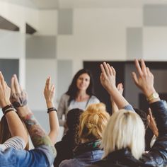 a group of people raising their hands in the air