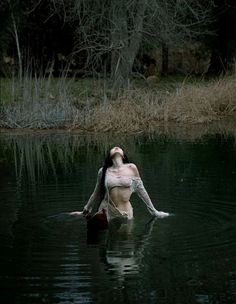 a woman is floating in the water with her hands on her hips