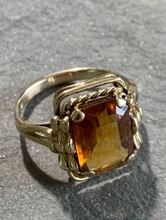 Tri-color orange citrine ring with 18k gold made by BIRKS, Bijoux Birks has been a leading designer of fine jewelry in Canada since 1879. This stone is a rectangular step cut with a decorative, Art Deco-like bezel -- really beautiful! I know it was made before 1990 but I'm not sure exactly when it was made. I had it made bigger at one point and it was polished and is in very good condition. The stone measures about 9mm by 12mm and the total weight is 5.2 grams. Orange Rings, Orange Citrine, Orange Ring, Jasper Ring, Step Cut, Citrine Ring, Purple Stones, Amethyst Earrings, Decorative Art