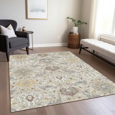 a living room with a couch, chair and rug on the hardwood floor next to a window