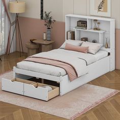 a white bed sitting on top of a wooden floor next to a pink rug and wall