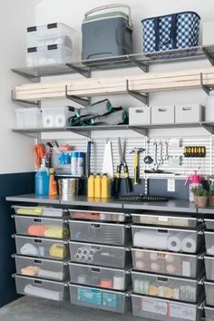 an organized garage storage area with bins and drawers