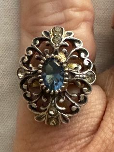 Beautifully crafted filigree sterling silver ring with lovely dark blue center crystal. Additional highlight rhinestones at 12-3-5-9 with doubles at 12 & 6. I believe the stones are crystals. the center stone at least is unfoiled. They may be glass and the price reflects glass indeed being the stones. I love the boho styling and the statement size. It fits my pinky, but on your ring finger, it's not smaller. In excellent condition with no signs of wear. Beautiful.  Please review all photos carefully. They do constitute a large portion of the description.  Measurements are approximate: size: US 5.5 Length:  1" Width:  3/4" Please note monitors display colors differently.  Thank you for looking. I am most grateful. Please check in often for new and interesting items.  You never know what mig Vintage Sterling Silver Rings, Sterling Silver Filigree, Boho Stil, Silver Filigree, Ring Finger, Blue Crystals, Sterling Ring, Rings Statement, Vintage Sterling Silver