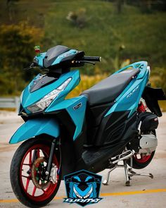 a blue motorcycle parked on top of a parking lot