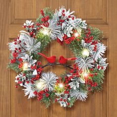 a christmas wreath with red birds on it