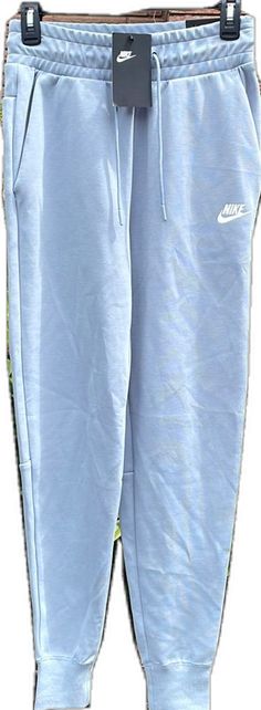 Blue Pants With Pockets For Leisure, Nike Cotton Pants For Spring, Nike Leisure Pants For Spring, Blue Sweatpants With Pockets For Leisure, Blue Summer Sweatpants For Loungewear, Blue Stretch Pants For Leisure, Blue Stretch Cotton Sweatpants, Light Blue Cotton Bottoms For Loungewear, Spring Nike Pants