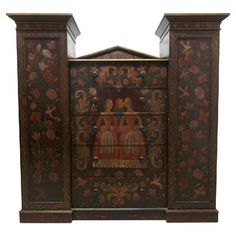 an ornate wooden cabinet with painted designs on it