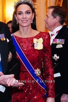 a man and woman standing next to each other in formal wear, wearing tiaras