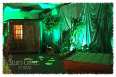 a room with green lights and plants on the walls