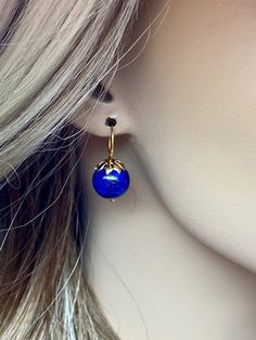 Beautiful vibrant and high-grade lapis lazuli globe earrings. The 12.5 mm lapis lazuli globes have a gorgeous deep vibrant royal blue color that shows celestial flecks of golden pyrite in the stone. The ultra-fine globes attached to a beautiful 14K gold-filled flower caps as they attached the vermeil on sterling ear wires. These are elegant and perfect earrings to go with any outfit. A pair of fine gemstone essentials. *Ball size (diameter): 12.5 mm *Metal: vermeil on sterling *Earrings drop len Round Lapis Lazuli Gemstone Earrings, Blue Lapis Lazuli Earrings For Formal Occasions, Pierced Lapis Lazuli Round Jewelry, Royal Blue Lapis Lazuli Round Jewelry, Formal Blue Lapis Lazuli Earrings, Royal Blue Lapis Lazuli Jewelry, Royal Blue Round Lapis Lazuli Jewelry, Ball Earrings Gold, Globe Earrings