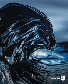 an image of a wave that looks like it has been wrapped in black plastic paper