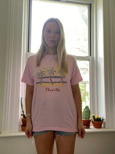 "Vintage pink Florida tee from the 1980s - 1990s  Made in U.S.A.  Fabric: 50% cotton 50% polyester  Tag: Screen Stars, adult size XL  Best fits a modern US size M - XL  Measurements: laying flat  Length: 29\"  Width: 21.5\"  Sleeve: 7\"  Condition: Very good vintage condition. Light pilling but no stains or holes" 90s Inspired Pink Short Sleeve Top, 90s Inspired Pink T-shirt For Spring, Retro Pink T-shirt For Streetwear, 90s Inspired Pink T-shirt For Streetwear, 90s Inspired Pink Streetwear T-shirt, 90s Inspired Pink Relaxed Fit Tops, 90s Style Pink T-shirt With Letter Print, 90s Style Pre-shrunk T-shirt For Summer, Pink Retro Graphic Print T-shirt