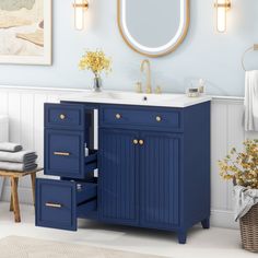 a bathroom with blue cabinets and white walls