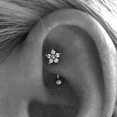 a woman's ear with three small flowers on it