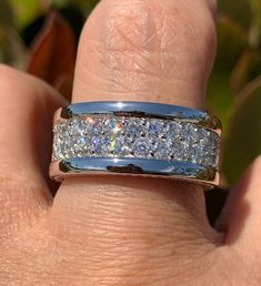 a close up of a person's hand with a wedding ring on their finger