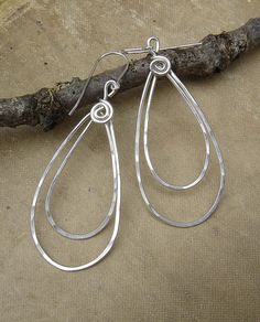 We hammered and swirled 18 gauge sterling silver wire to create these double teardrop loop earrings. They measure about 1 7/8 - 2 1/4( 4.9 - 5.9 cm) from the top loop to the bottom of the earrings. The earwires add about 1/2 making them a total length of about 2 1/2-2 5/8 (5.8-6.5 Earrings Long Silver, Silver Wire Jewelry, Celtic Knot Jewelry, Long Silver Earrings, Jewelry Knots, Earrings Teardrop, Silver Earrings Handmade, Earrings Long, Wire Earrings