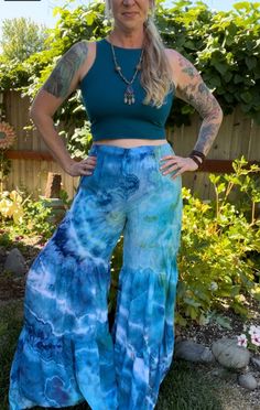 Made from 100% woven Rayon Light, these tiered pants have bohemian flare!   Comfortable and easy to wear with elastic waistband and two gathered tiers in the pant legs.  US Women's size small. measurements: waist: 14-21"(stretched) inseam: 32" rise: 14" hip: 23" Flowy Tiered Beach Bottoms, Flowy Tiered Bottoms For Beach, Flowy Wide-leg Bottoms With Ruffles, Flowy Ruffled Rayon Bottoms, Flowy Rayon Bottoms With Ruffles, Fitted Bohemian Festival Bottoms, Flowy Ruffled Bottoms In Rayon, Flowy Tiered Bottoms For Vacation, Boho Print Long Pants For Summer