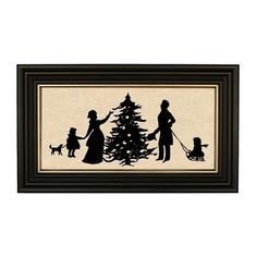 a family silhouetted in front of a christmas tree with a dog on a leash