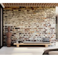 a living room with a brick wall and white flooring is pictured in this image