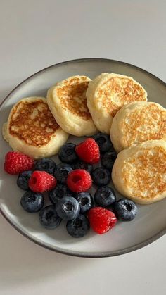 pancakes, berries and blueberries on a plate