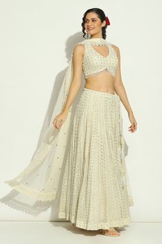 Ivory attached cancan lehenga with chikankari, swarovski embroidery in stripe pattern. Paired with halter neck embroidered padded blouse and cutwork border embroidered dupatta. - Aza Fashions Beige Georgette Lehenga With Zari Work, Cream Georgette Sharara For Reception, Beige Lehenga With Traditional Drape In Georgette, Beige Lehenga In Traditional Drape Style, Traditional Drape Beige Georgette Lehenga, Beige Georgette Lehenga, Fitted Beige Georgette Lehenga, Beige Choli With Sheer Dupatta, Off White Sets With Chikankari Embroidery For Party