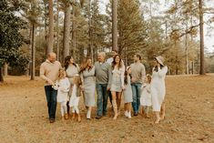 a group of people standing next to each other in the woods