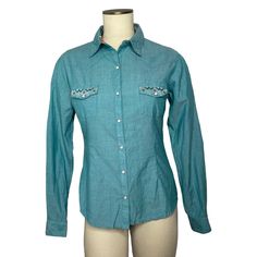 New With Tags Panhandle Womens Aztec Embroidery Geo Printed Long Sleeves Western Snap Shirts Designed In Usa Rock & Roll Cowgirl Long Sleeve Embroidery Spread Collar Snap Buttons Closure Snap Flap Pockets 97% Cotton, 3% Spandex Color: Turquoise Size: S Pit To Pit 19” Length 24/5” S7 Western Blue Button-up Top, Western Style Blue Tops For Spring, Casual Turquoise Cotton Blouse, Turquoise Cotton Blouse, Cowgirl T Shirt, Aztec Embroidery, Lace Knit Top, Boho Pullover, Sleeve Embroidery