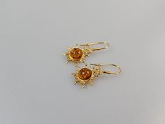 One pair of Amber earrings. Beautifully designed flaming sun shaped golp plated sterling silver. Sterling silver 925 with hallmarks. Ear wire closure  gemstone earring. Cyrstal earing. Handmad esilver earring.  Natural brown Baltic Amber colour available.  About 3,5  cm length Weight 2,85 gr.  Small gift Idea for Christmas or Birthday. This item was made of natural Baltic Amber. All the amber used in my jewelry is collected in my home country Lithuania.  I sell only genuine,  real, not pressed, Elegant Sunburst Earrings As A Gift, Gold Sunburst Earrings With Sun Design, Gold Sun-shaped Earrings For Gift, Gold Sunburst Earrings For Gift, Sunburst Earrings As Gift, Gold Drop Earrings With Sun Design, Gold Jewelry With Sun Design Drop Earrings, Elegant Dangle Earrings With Sun Design, Elegant Sun Design Dangle Earrings