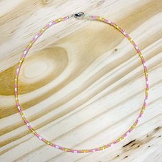 Approximately 15 inches long Made with seed beads on silver wire to prevent wear Spring ring closure stackable and dainty Adjustable Silver Heishi Beads Necklace, Adjustable Dainty Beaded Necklace With Spacer Beads, Dainty Yellow Jewelry With Tiny Beads, Minimalist Adjustable Silver Beaded Necklaces, Adjustable Pink Beaded Necklaces With Silver Beads, Adjustable Pink Beaded Necklace With Silver Beads, Dainty Adjustable Beaded Chain Necklaces, Dainty Silver Beaded Necklaces, Dainty Silver Beaded Necklace